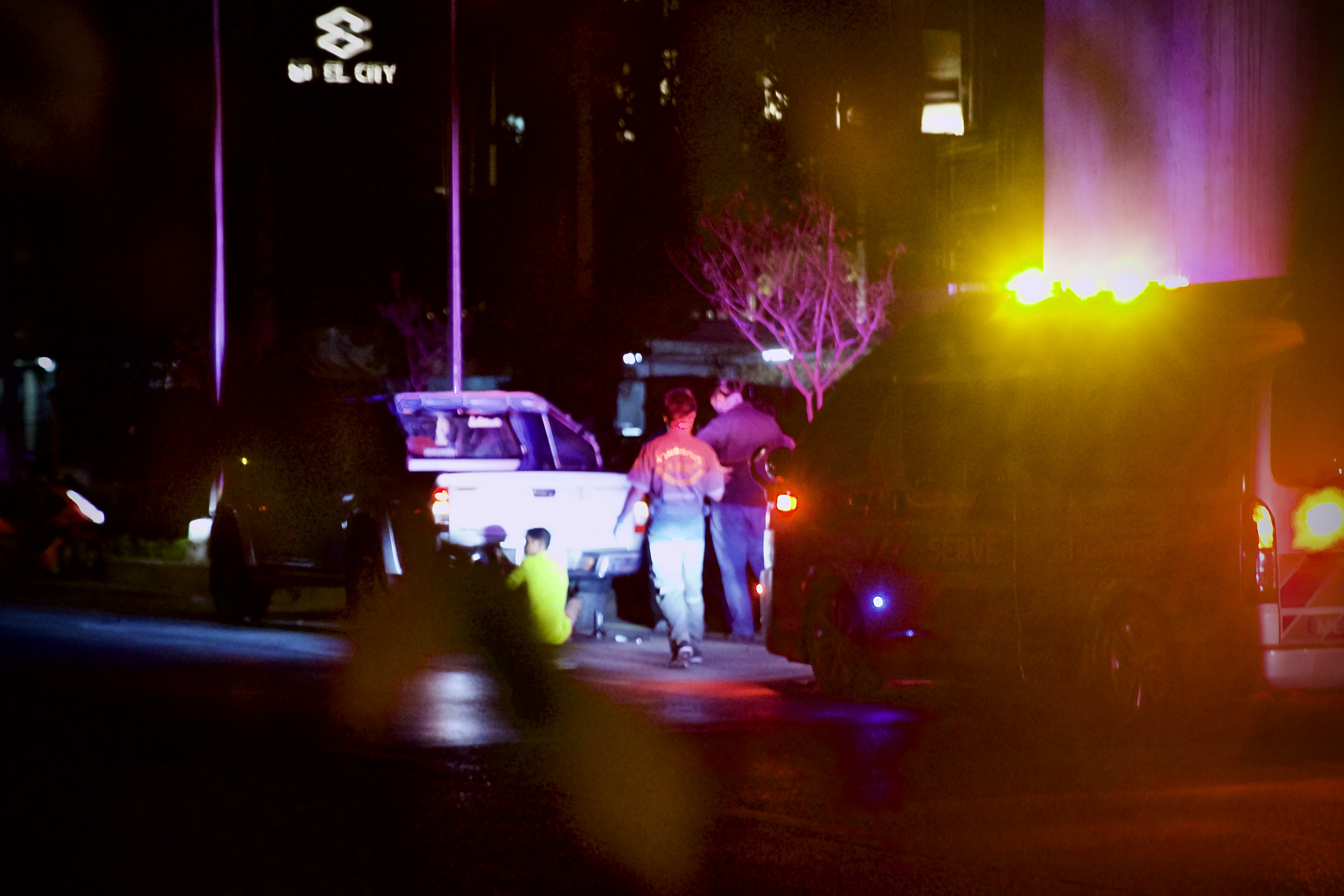 Night street scene lit by emergency lights